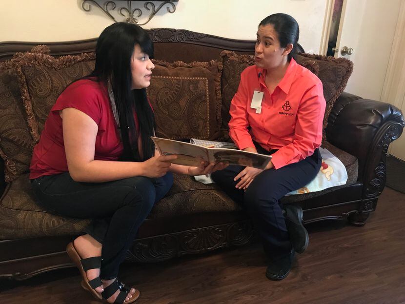 Alejandra Camarillo (left) goes over a reading activity with HIPPY instructor Abigail Ponce. 