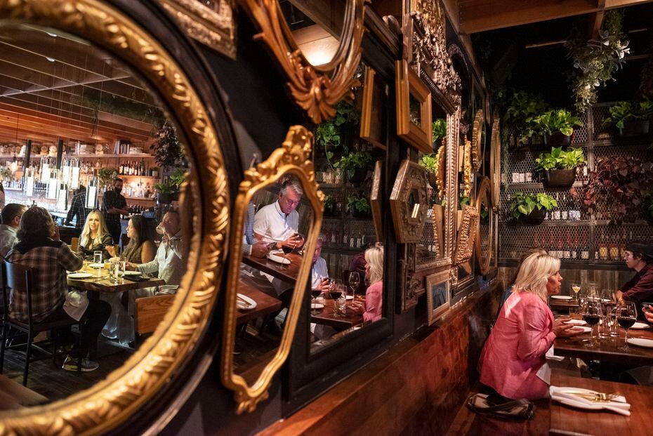 A wall covered in mirrors decorates the dining area inside Rye on Lowest Greenville in Dallas.