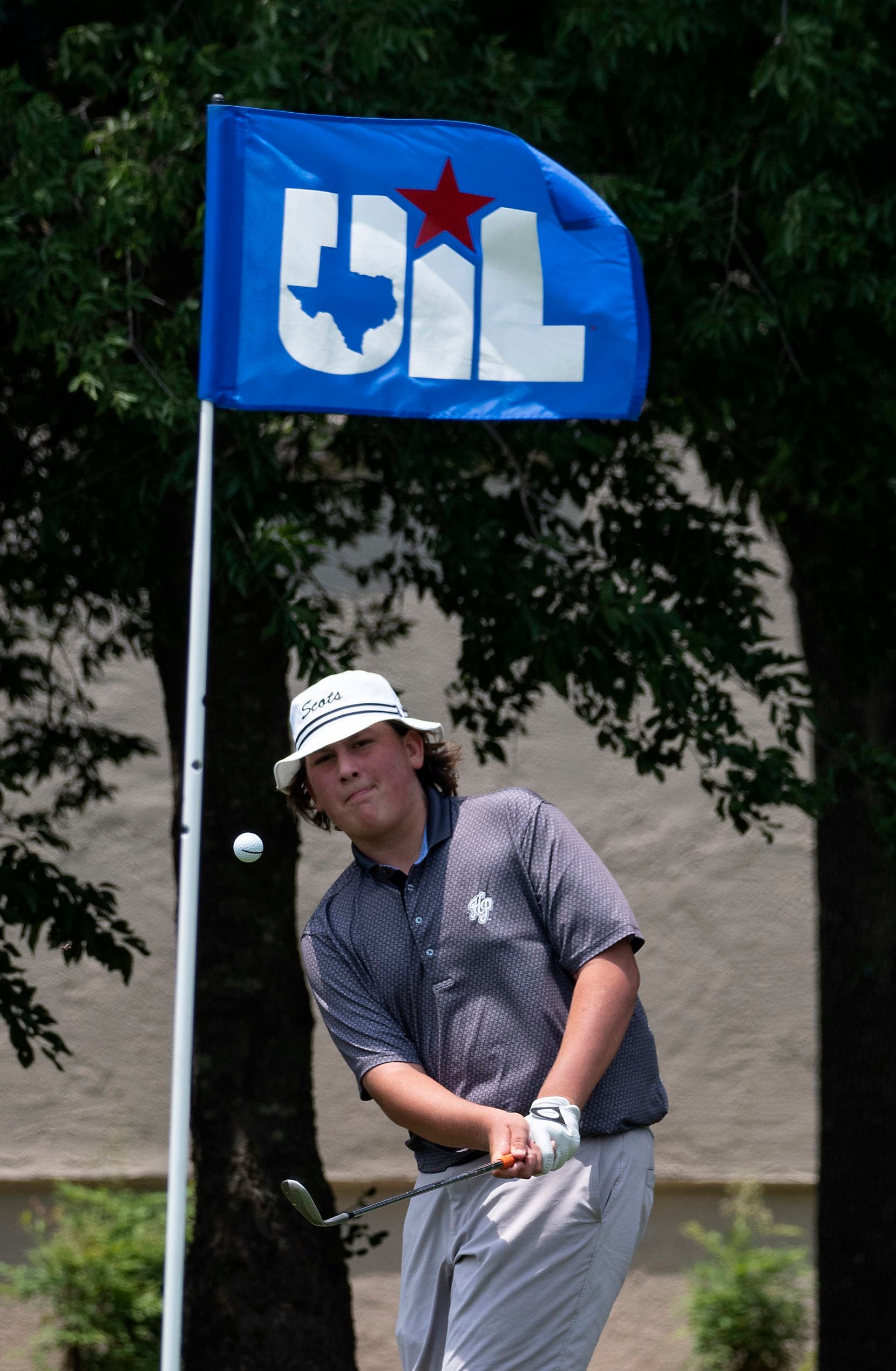 Highland Park, Brooks Simmons, chips onto the no. 14 green during the first round of UIL...