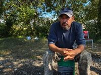 Jose  Bos  Boanerges Hernandez Alfaro cools down under the shade in the tree line behind a busy barbeque and grill restaurant in McKinney. He spends his days at this spot because he is homeless after the city purchased Dungan s Mobile Home Community.