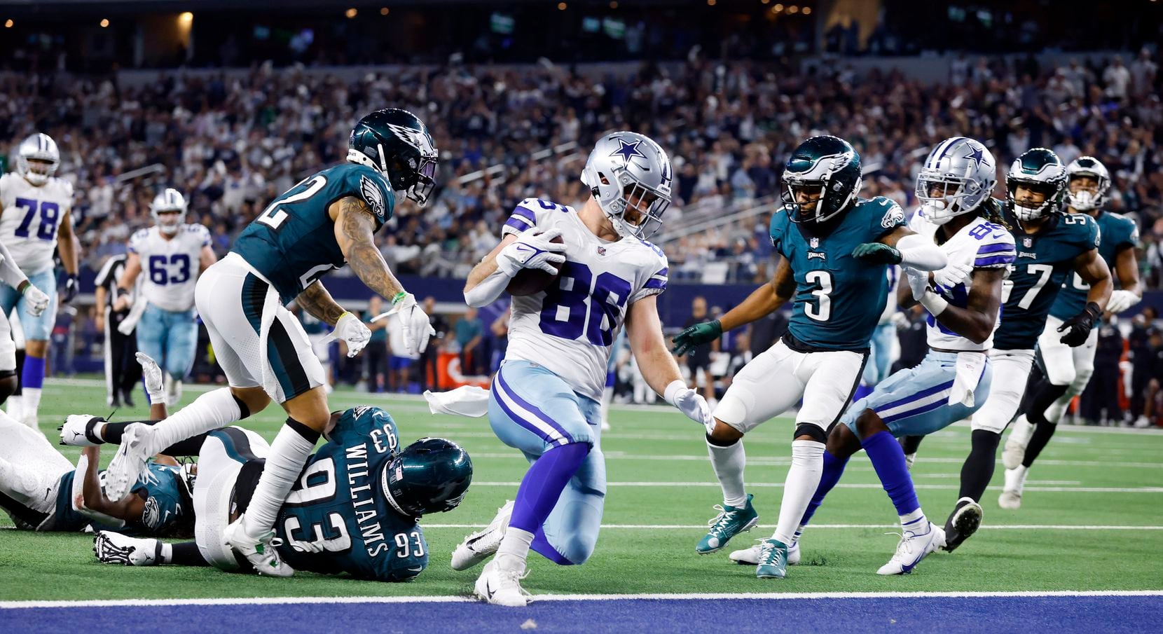 Dallas Cowboys tight end Dalton Schultz (86) slides into the end zone after running in a fourth quarter completion against the Philadelphia Eagles defense at AT&T Stadium in Arlington, Monday, September 27, 2021. (Tom Fox/The Dallas Morning News)