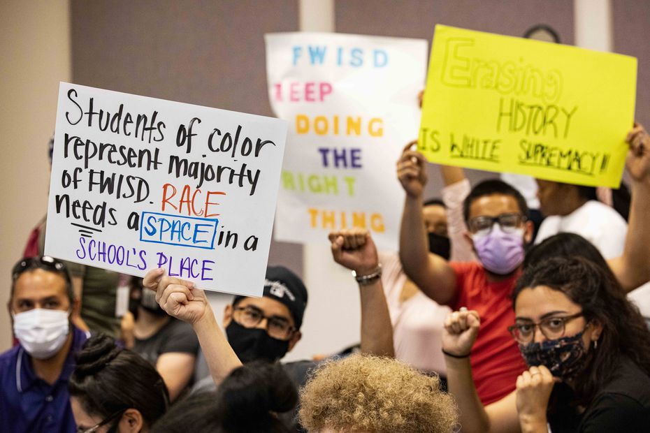 Community members in support of equity conversations in schools held signs on Tuesday during the Fort Worth ISD board meeting. (Juan Figueroa/The Dallas Morning News)