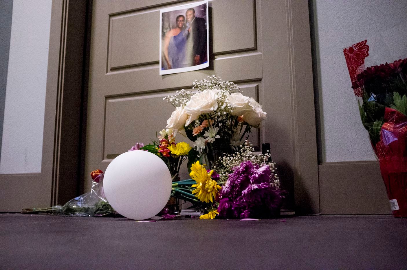 Flowers are placed at the front door apartment of Botham Jean on Monday, Sept. 10, 2018 in Dallas. Jean was shot Thursday by off-duty Dallas police officer Amber Guyger, who says she mistook his apartment for hers.