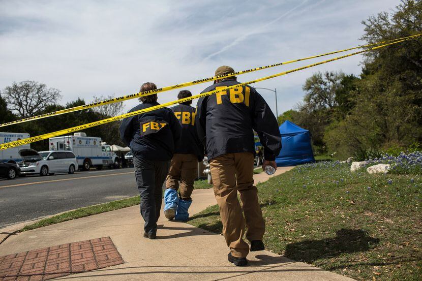 FBI agents at the scene of Sunday's explosion that injured two people in southwest Austin,...