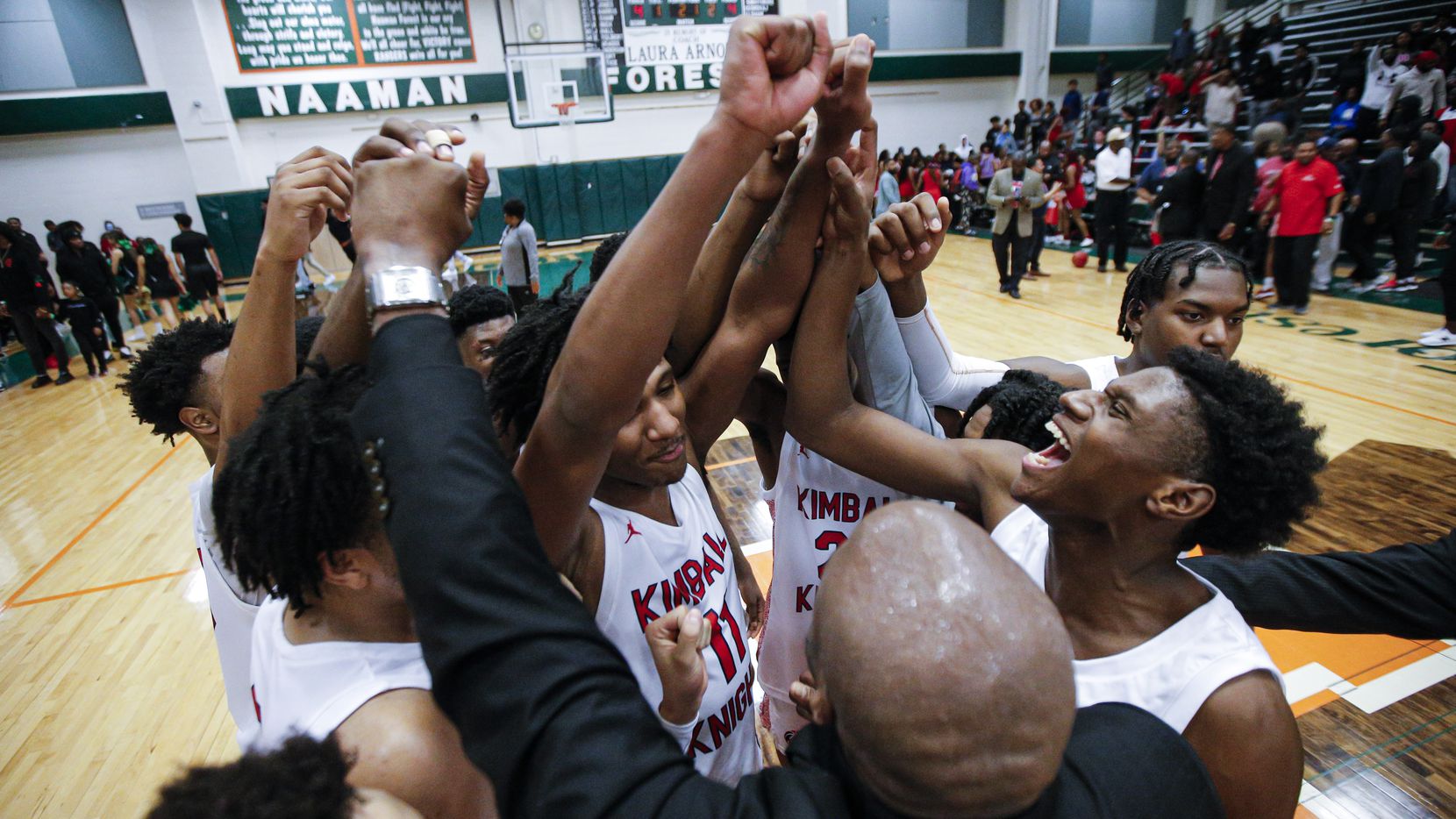 Kimball celebrates a 101-73 win over Newman Smith after a Class 5A Region II quarterfinal boys basketball game at Naaman Forest High School in Garland, Tuesday, March 3, 2020.