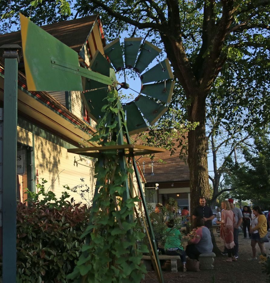 The late afternoon sun highlights the windmill at the Antiques on Bishop shoppe in the...