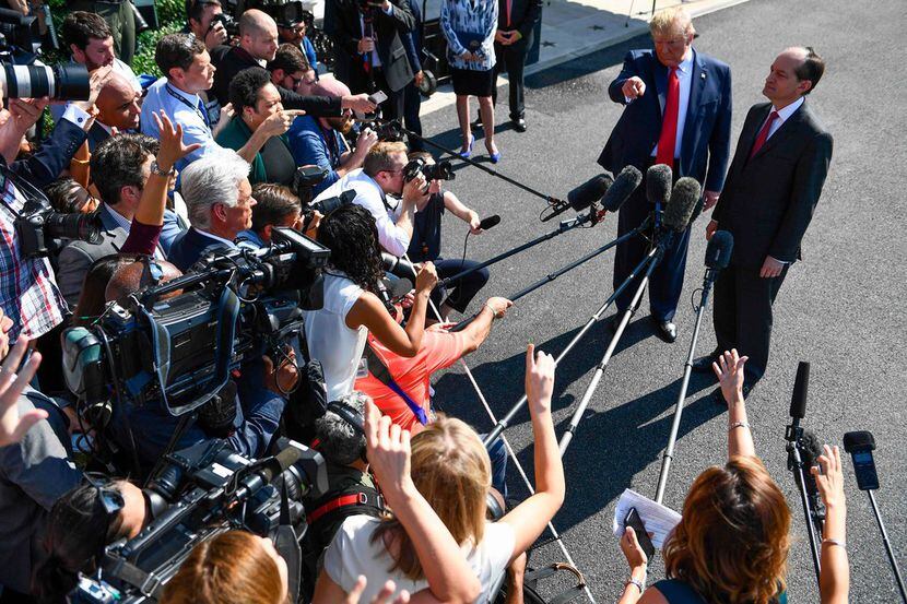 President Donald Trump and Labor Secretary Alexander Acosta address the media early July 12,...
