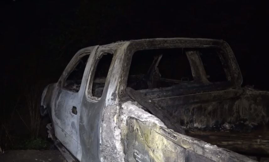 A charred pickup sits in a wooded area in Fort Worth after it caught fire Monday night. The...