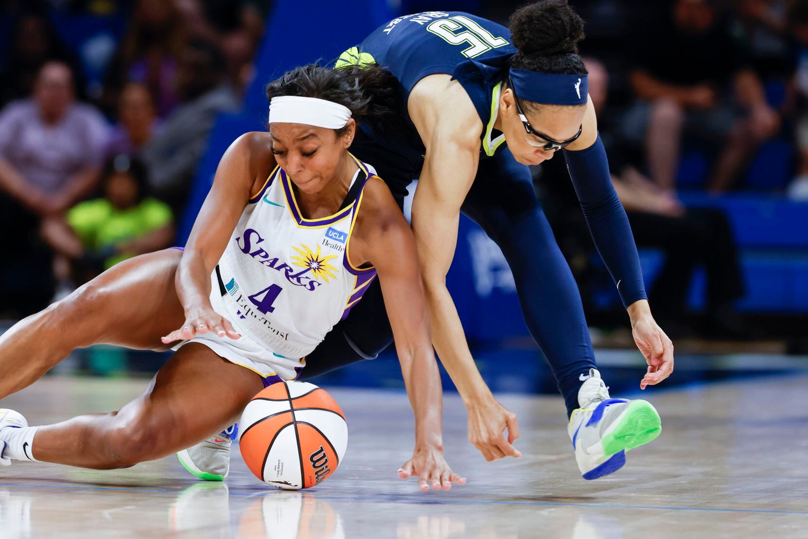 Los Angeles Sparks guard Lexie Brown (4) and Dallas Wings guard Allisha Gray clashes during...