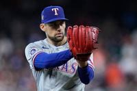 Texas Rangers starting pitcher Nathan Eovaldi gets set during the first inning of a baseball...
