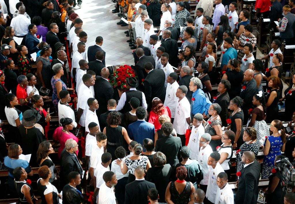 Botham Jean is carried by pallbearers and followed by family at the start of the funeral at Minor Basilica of the Immaculate Conception in Castries, St. Lucia on Sept. 24, 2018. Jean was shot and killed in his apartment by off-duty Dallas police officer Amber Guyger.