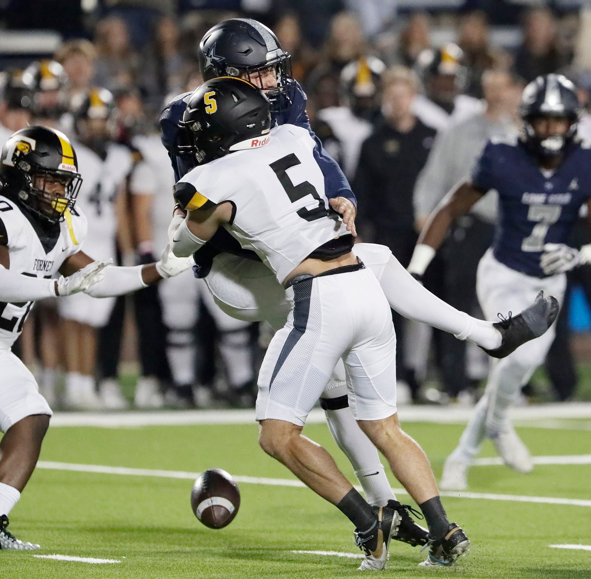 Lone Star High School punter Chase Lanham (88) has his punt blocked by Forney High School...