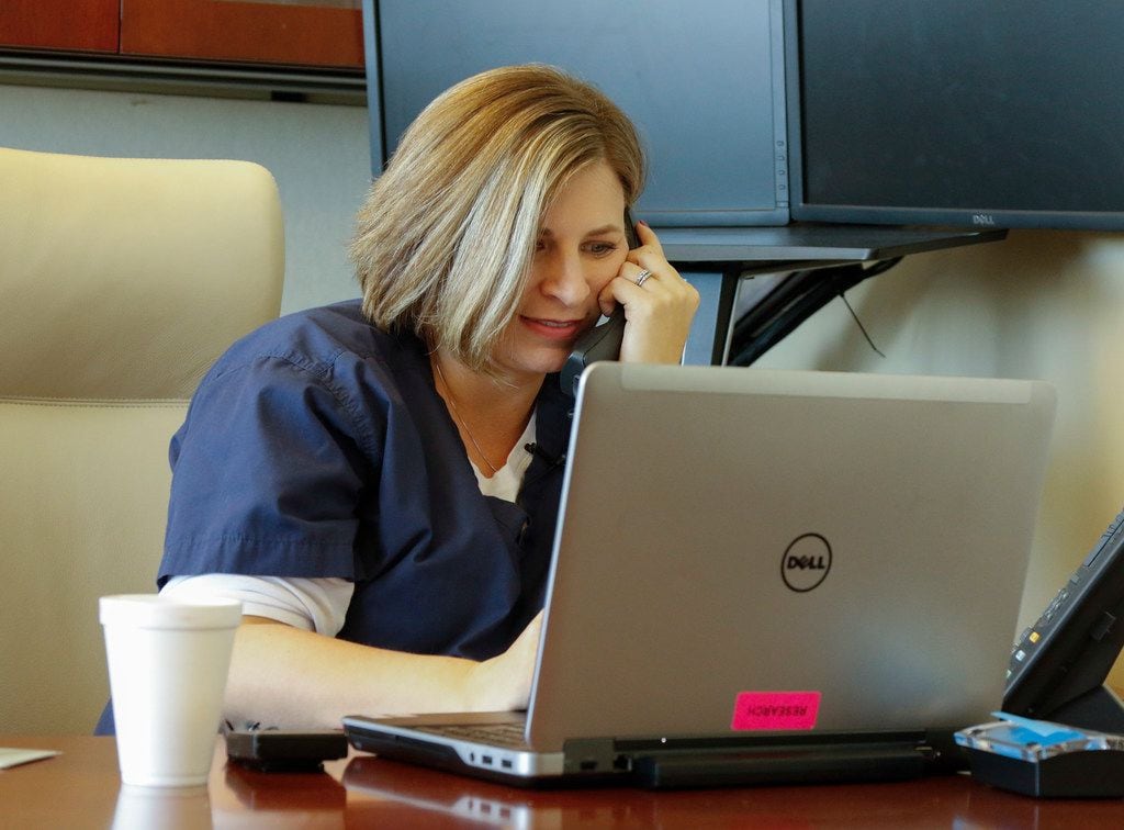 Kristin Posey Wallis, uterus transplant nurse, works to return phone calls to interested...