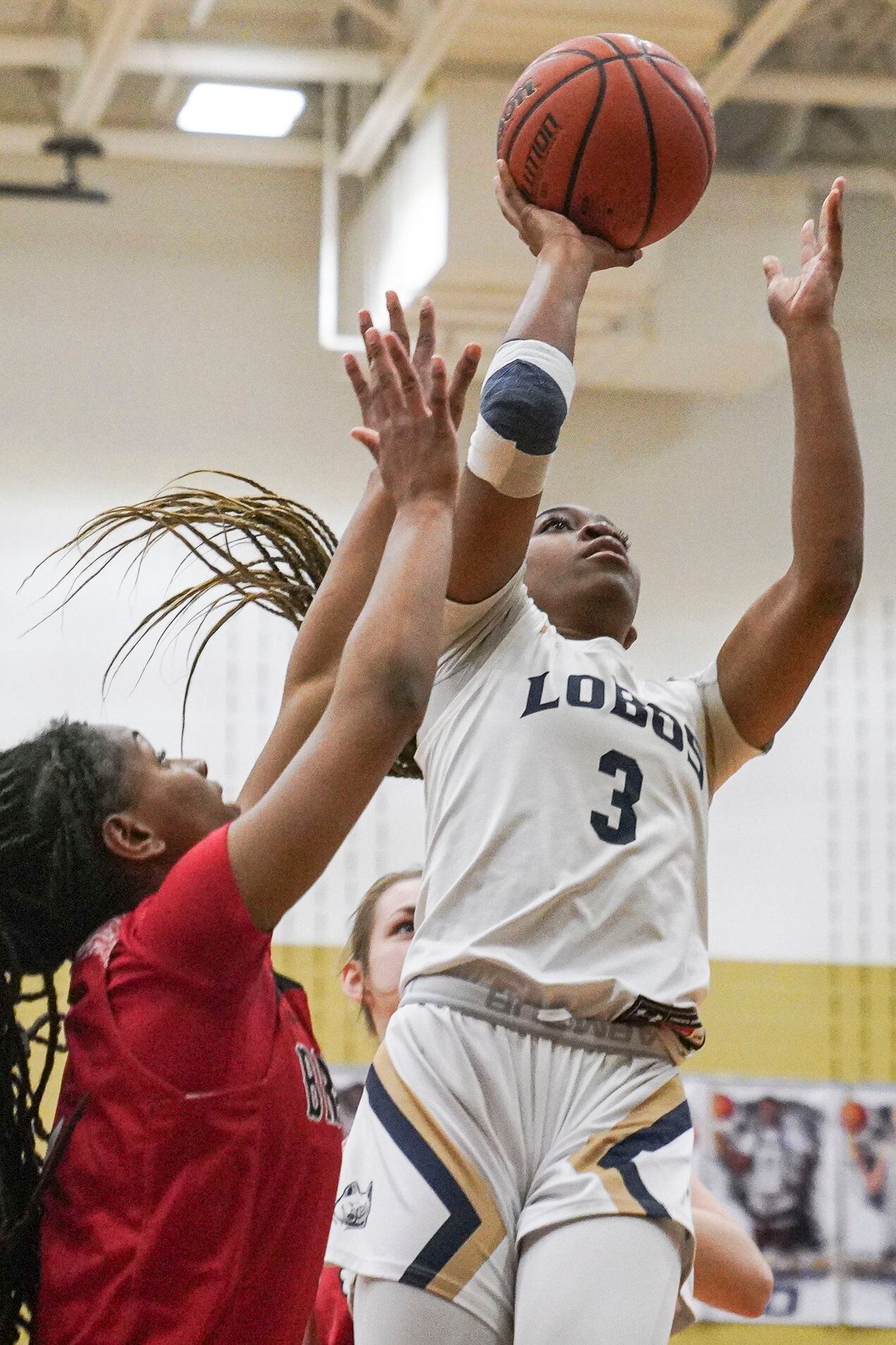 Little Elm High School’s Amarachi Kimpson (3) shoots while defended by Denton Braswell High...