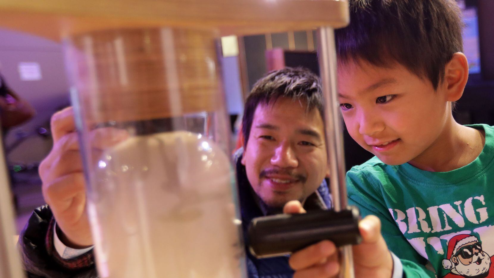 Takamichi Ono, left, and 6-year-old Masato Ono enjoy Sci-Tech Discovery Center in Frisco.