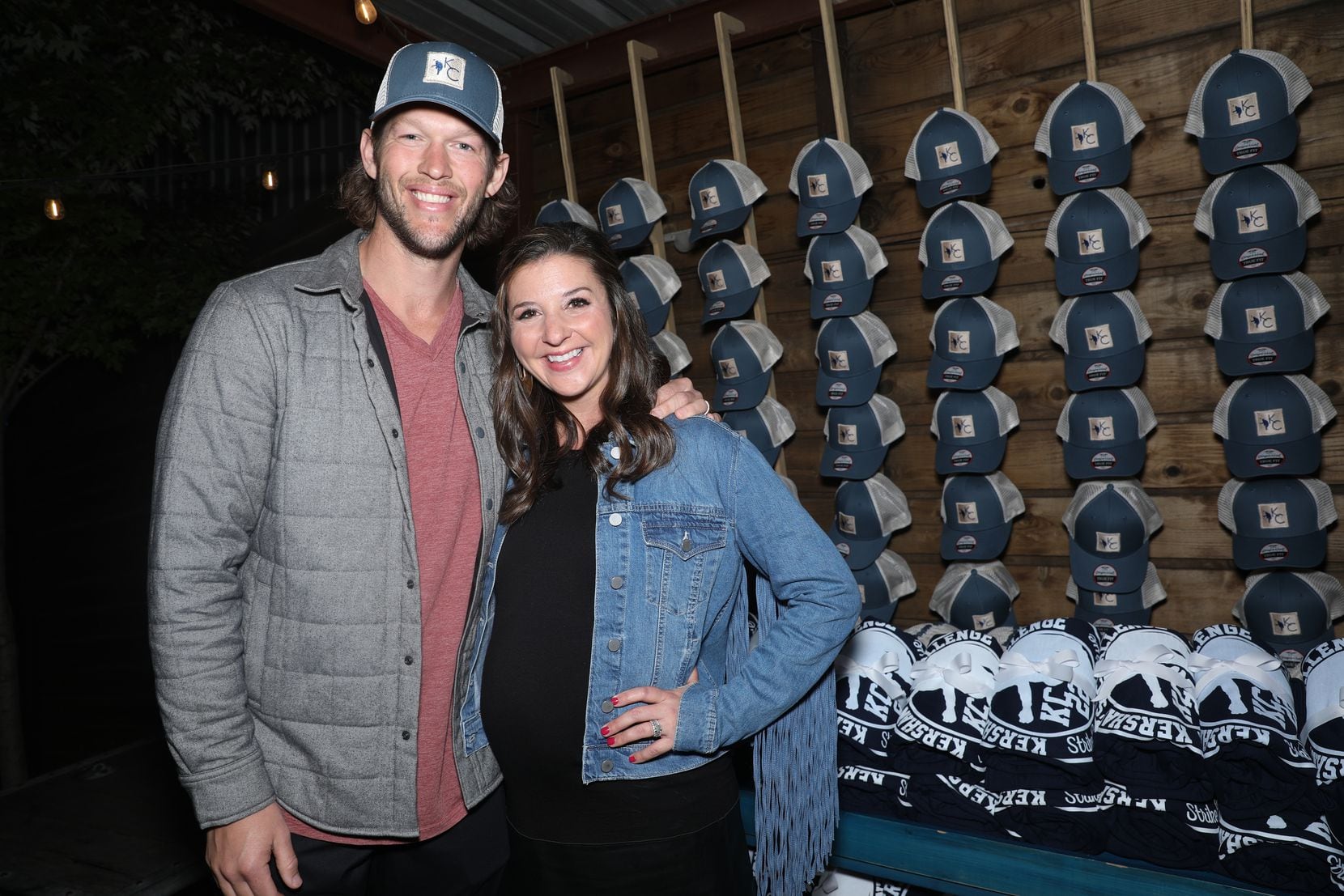 Clayton Kershaw and Ellen Kershaw pose in front of Kershaw's Challenge merchandise at the...