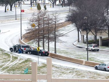 An SUV sits stuck on an exit ramp of U.S. 75 in Dallas on Wednesday, Feb. 1, 2023. A half...