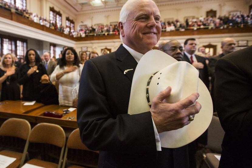 Agriculture Commissioner Sid Miller held his cowboy hat over his heart during the singing of...
