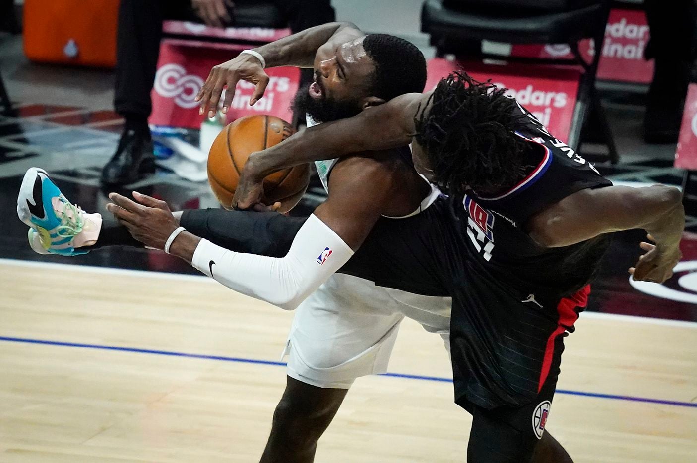 Dallas Mavericks forward Tim Hardaway Jr. (11) is fouled by LA Clippers guard Patrick Beverley (21) during the second half of an NBA playoff basketball game at Staples Center on Tuesday, May 25, 2021, in Los Angeles. The Mavericks won the game 127-121.