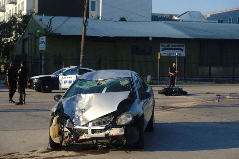 Dallas police officers were on the scene of a collision between a Dodge Neon and a...