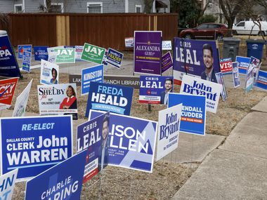 Various campaign signs fill the grass during the first week of early voting outside Lakewood...