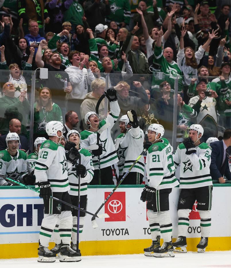 Dallas Stars players and fans celebrate after seeing the video replay of the puck cross the...