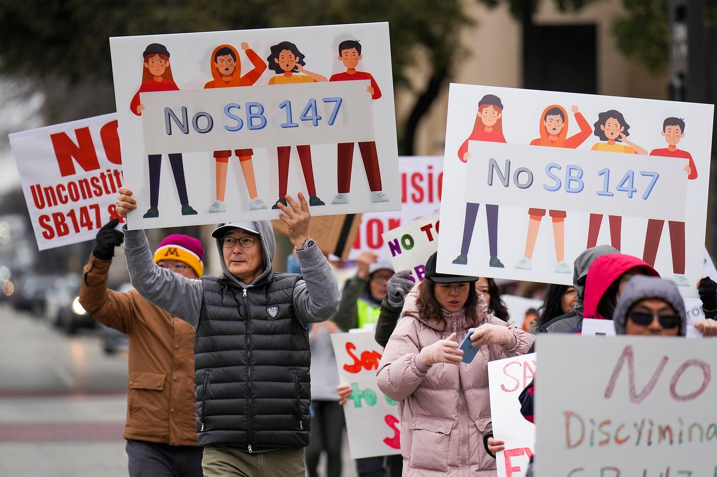 Demonstrators march in opposition to Texas Senate Bills 147 and 552 on Sunday, Jan. 29,...