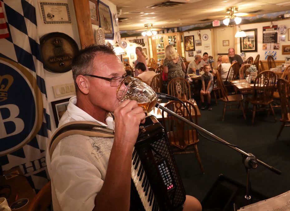 Alan Walling sipped a beer as he played traditional German music on the accordion at...