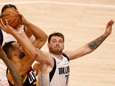 Dallas Mavericks guard Luka Doncic (77) fouls Utah Jazz center Rudy Gobert (27) as he grabs...