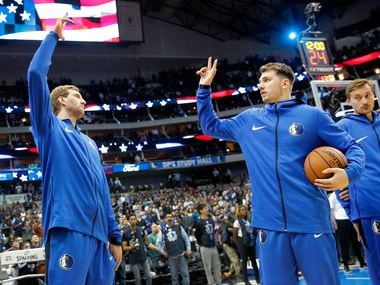 Dallas Mavericks forward Dirk Nowitzki (left) and Dallas Mavericks forward Luka Doncic hgh five following the national anthem before facing the Minnesota Timberwolves at the American Airlines Center in Dallas, Wednesday, April 3, 2019.