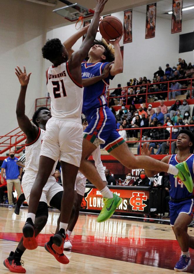 Duncanville guard Anthony Black (0), center, gets off a contested shot against the defense of Cedar Hill's Jeremy Watkins (21) during first half action. The two teams played their District 11-6A boys basketball game at Cedar Hill High School in Cedar Hill on January 14, 2022. (Steve Hamm/ Special Contributor)