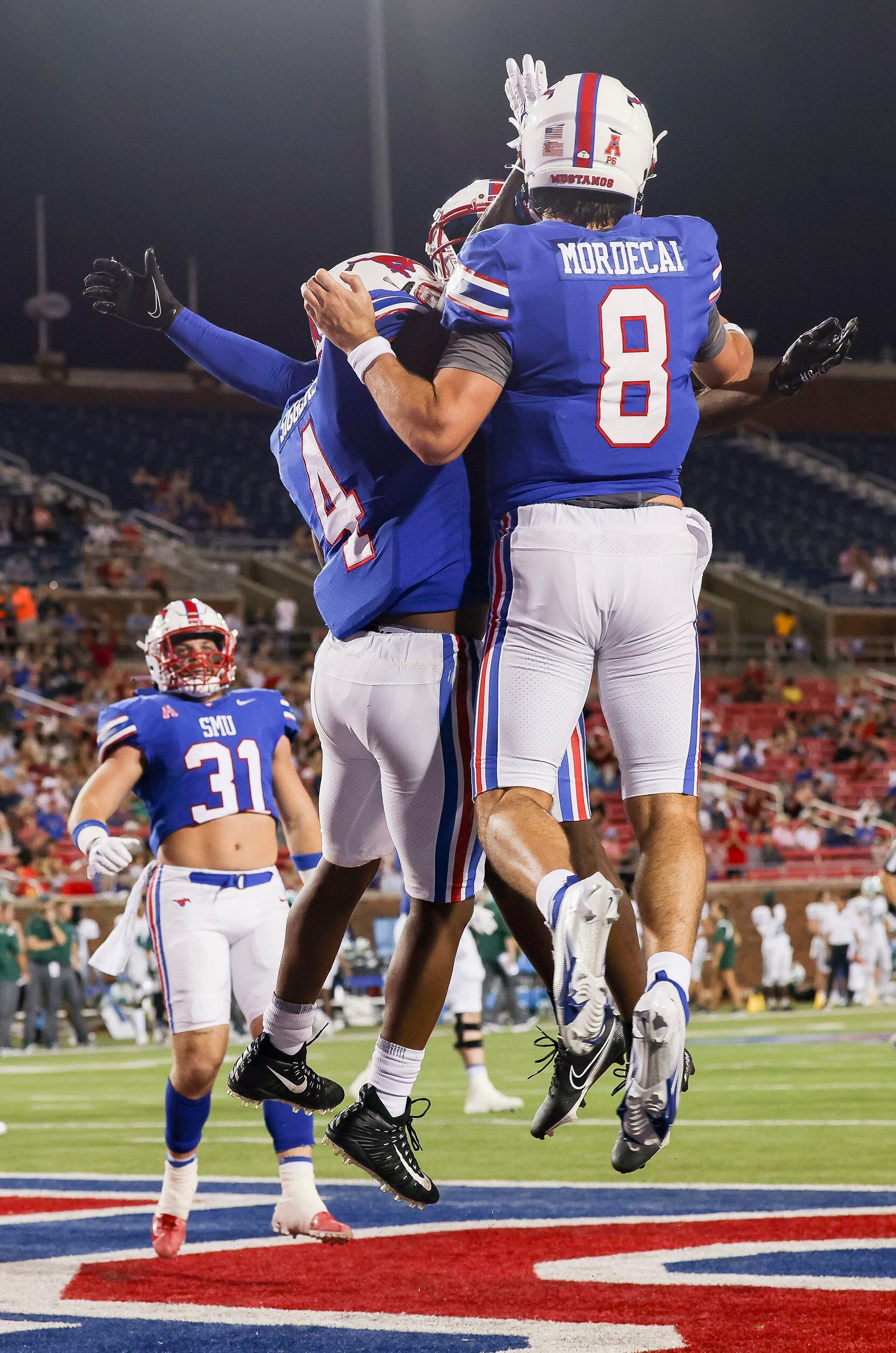 Southern Methodist Mustangs quarterback Tanner Mordecai (8) celebrates a touchdown with...