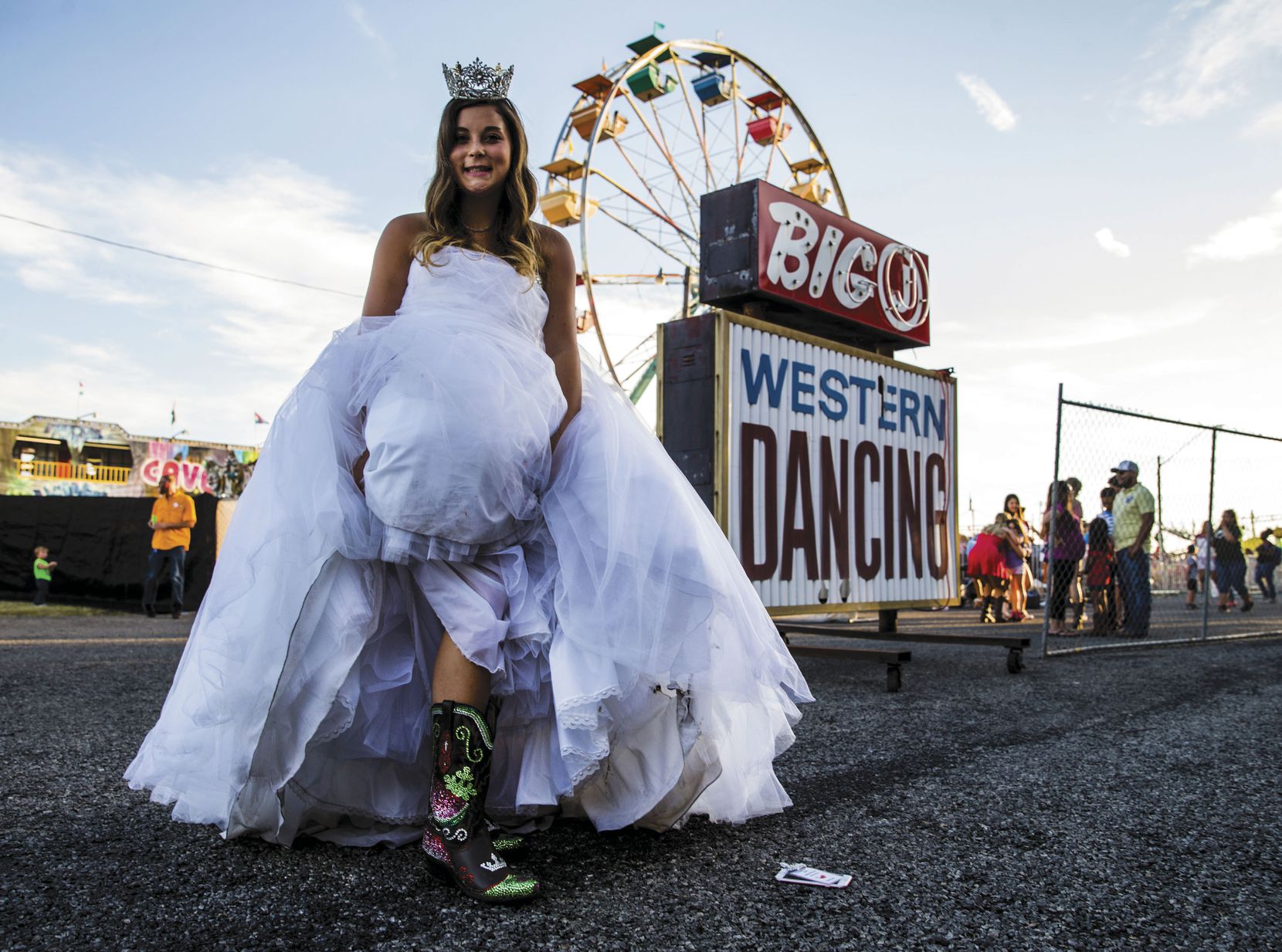 Lexi Carter, the Luling Watermelon Thump Queen 2016, shows off her custom-made cowboy boots after the coronation of the 2017 queen. The pageant is held at the Thump Pavilion.