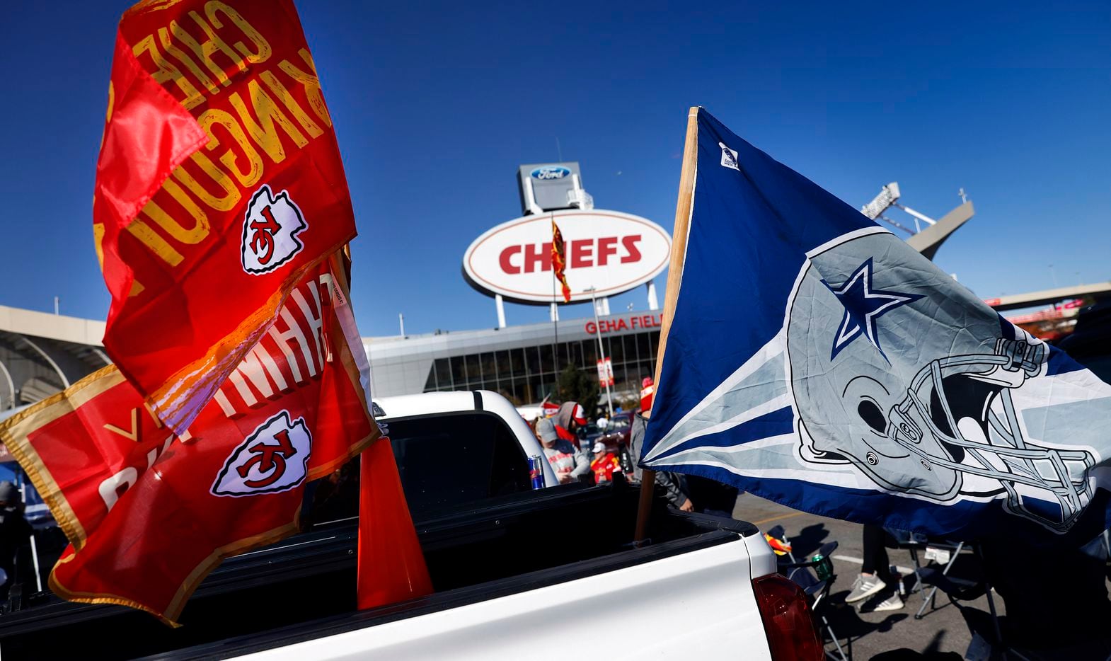 Dallas Cowboys and Kansas City Chiefs flags fly from the back of a pickup during a pregame...