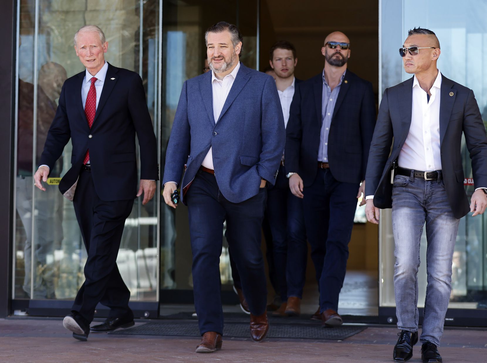 Flanked by Colleyville Mayor Richard Newton (left), Sen. Ted Cruz leaves Colleyville City Hall following a roundtable meeting with city officials and Jewish community leaders Friday.