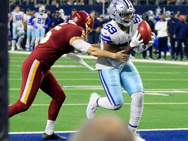 Dallas Cowboys defensive end Chauncey Golston (59) recovers a blocked punt for a touchdown...