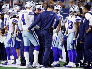 Dallas Cowboys quarterback Dak Prescott (4) shows his throwing hand to head coach Mike...
