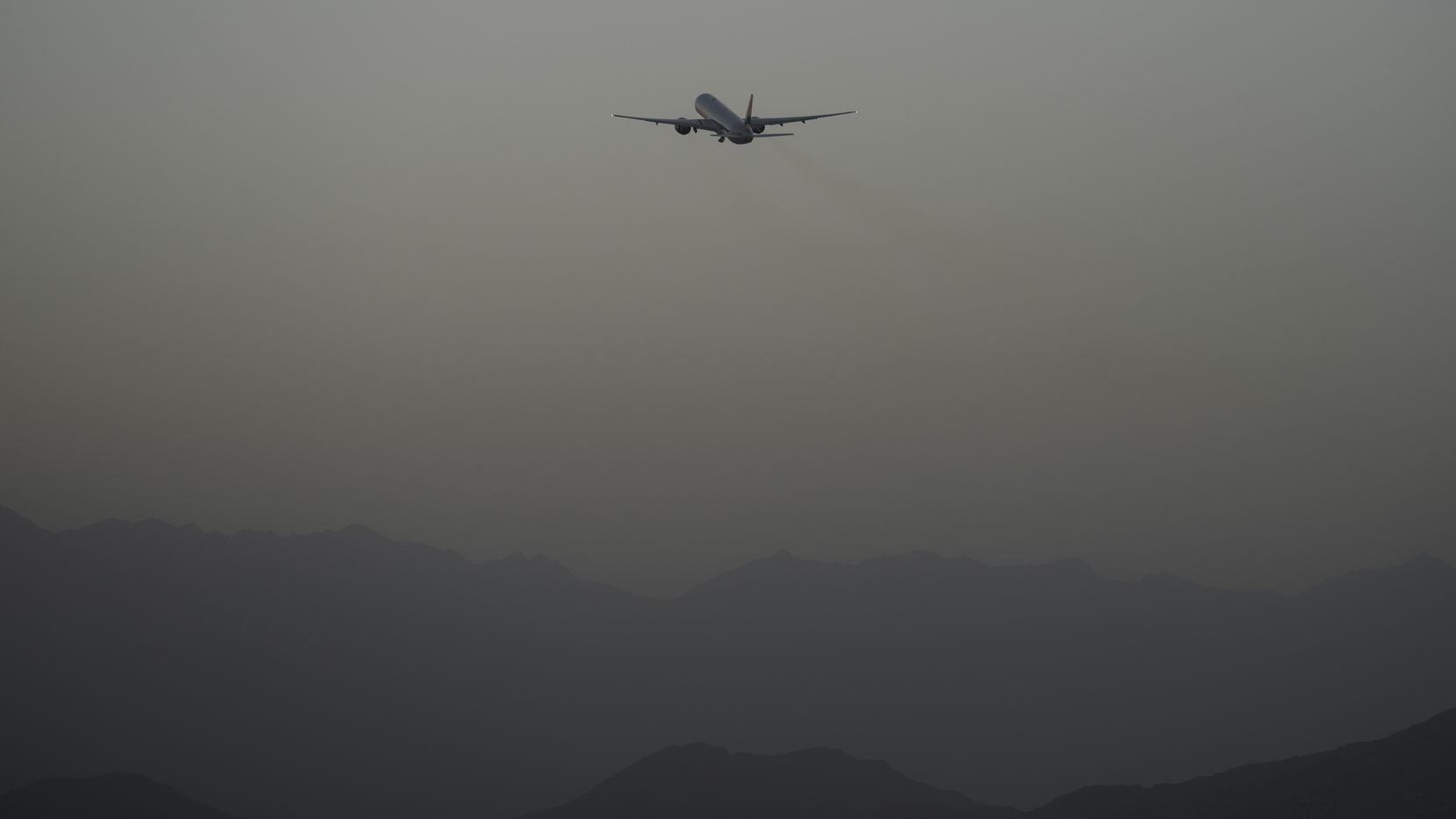 A Qatar Airways aircraft takes off with foreigners from the airport in Kabul, Afghanistan,...