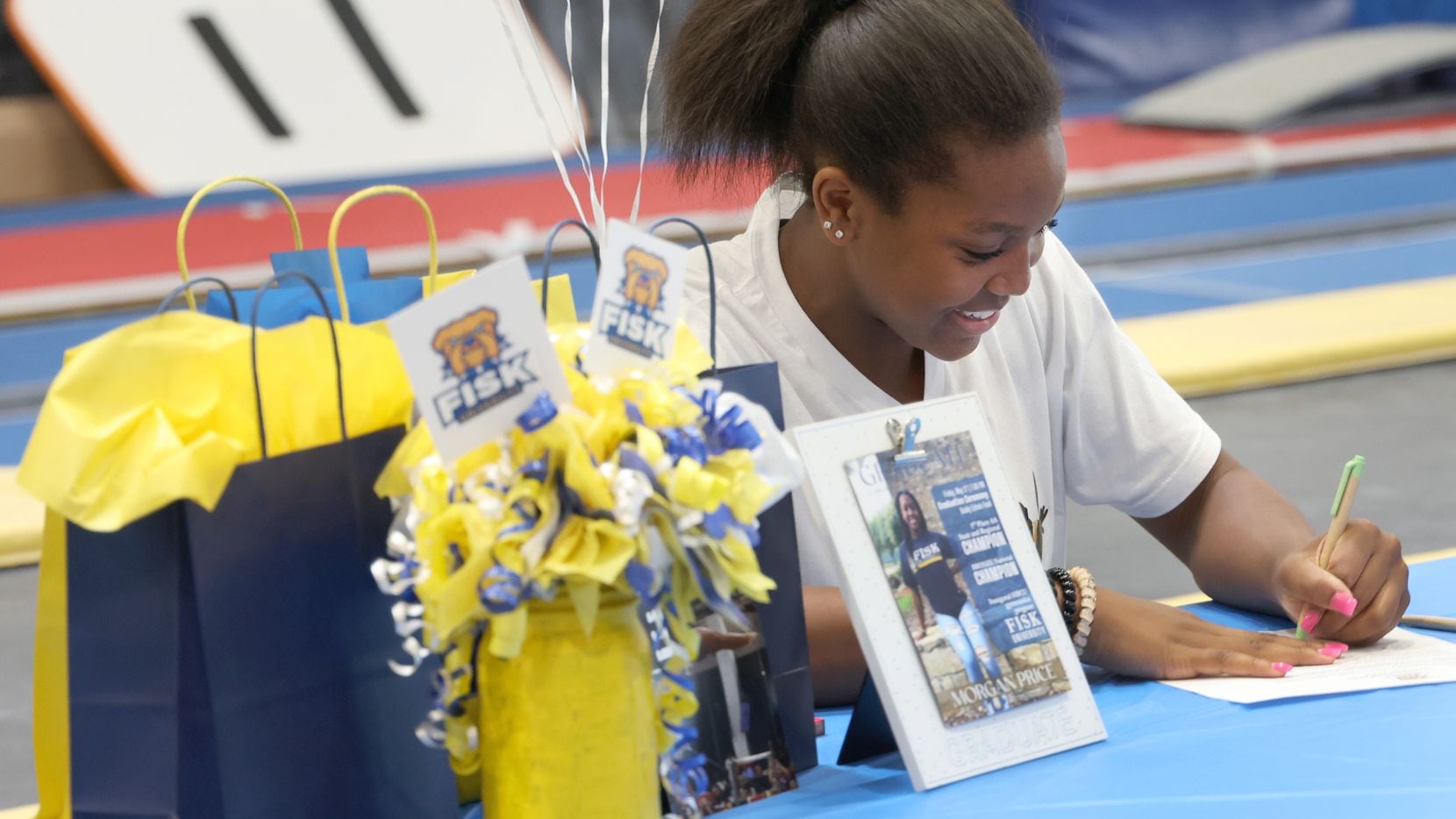 Morgan Price, 16-year-old graduate of Coppell High School, signs her letter of intent to...