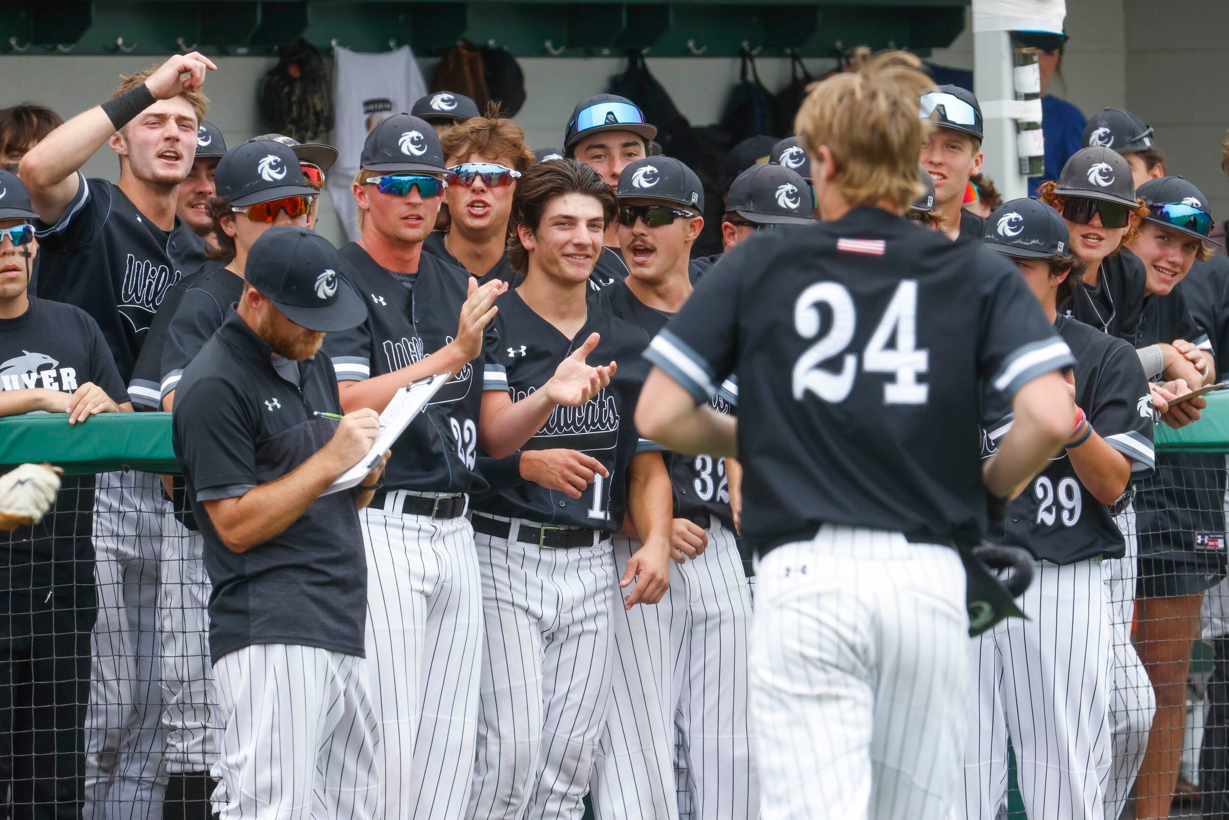 Denton Guyer players cheer for Brad Pruett (24) after a homer during a baseball game against...