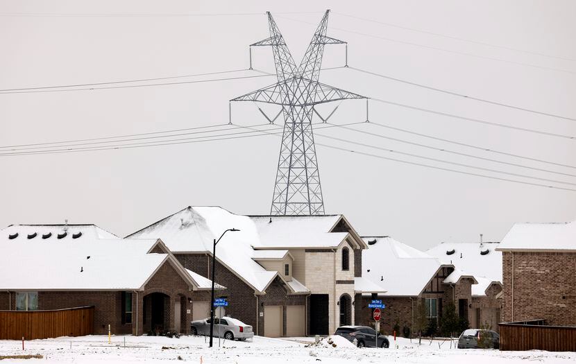 Large electrical transmission lines are seen in a new housing development in South Arlington...