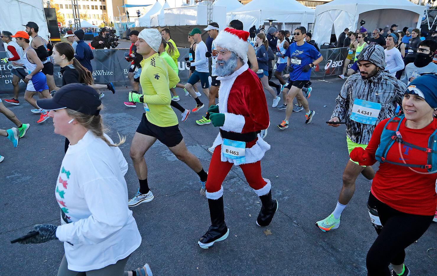 A runner dresses as Santa Claus at the start of the half marathon as the Dallas Marathon...