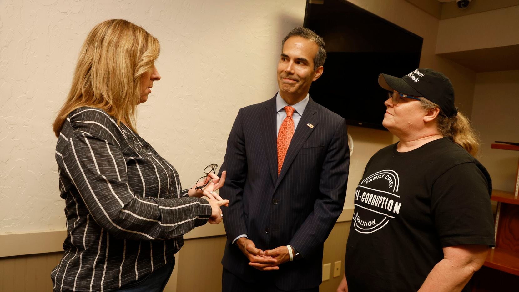 Melanie Fletcher, left, and Jodi Mueller, right talk to George P. Bush, who is in a runoff...