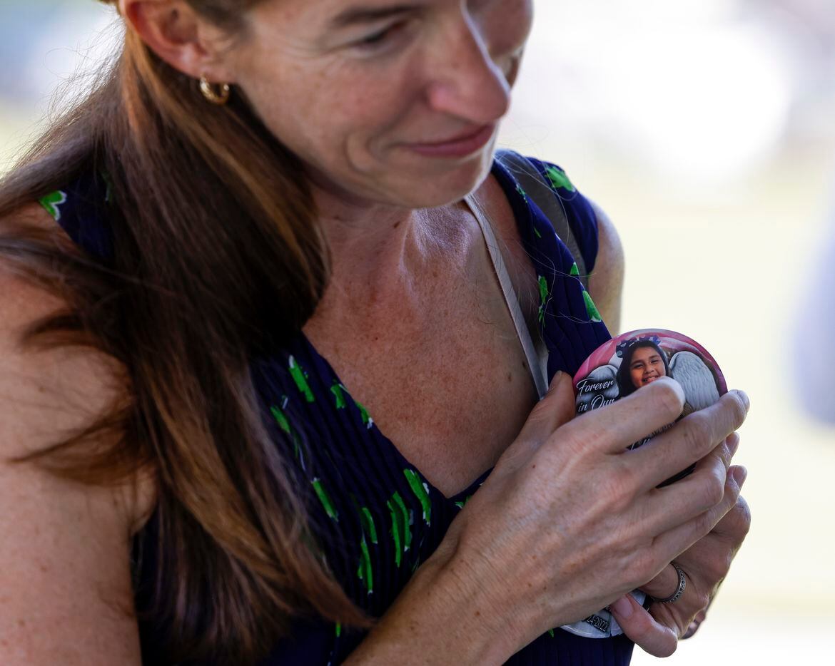 Amy, wife of Democratic gubernatorial candidate Beto O'Rourke puts on a badge dedicated to...