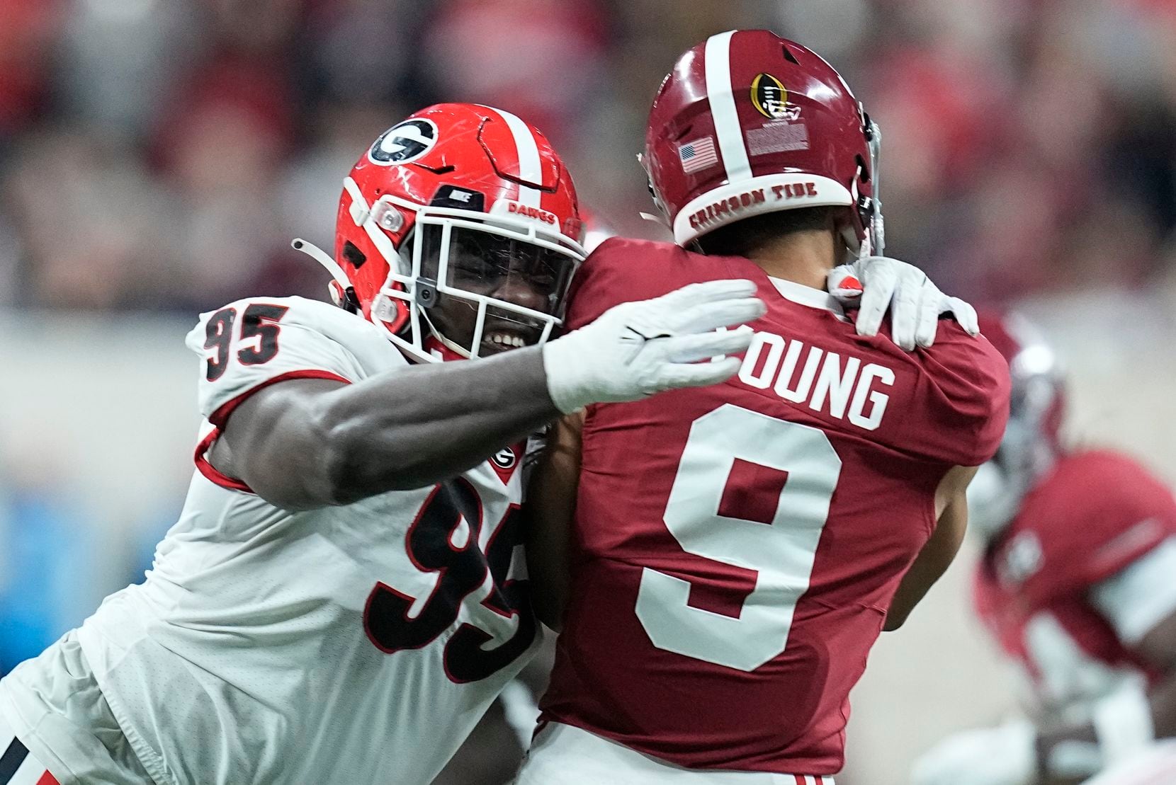 Georgia's Devonte Wyatt hits Alabama's Bryce Young as he throws during the first half of the...
