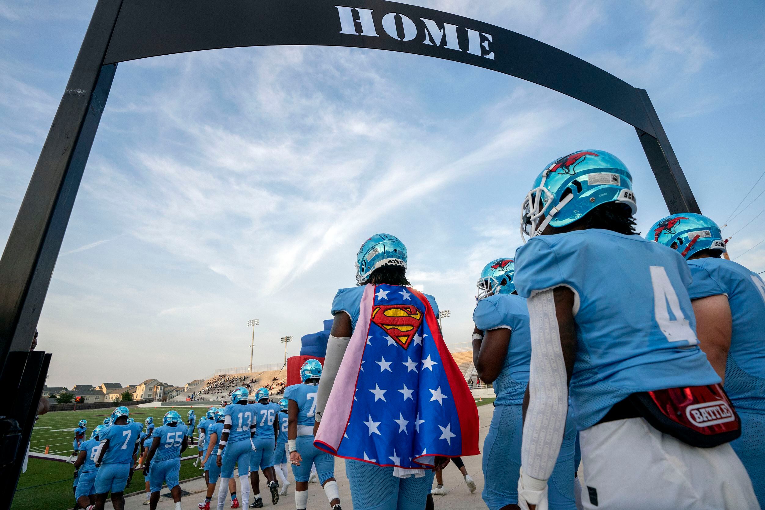 Skyline senior quarterback Darryl Richardson (2) wears a Superman cape as he takes the field...