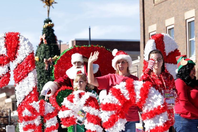 Community members participate in a parade during the Old Town Holiday Stroll in Lewisville.