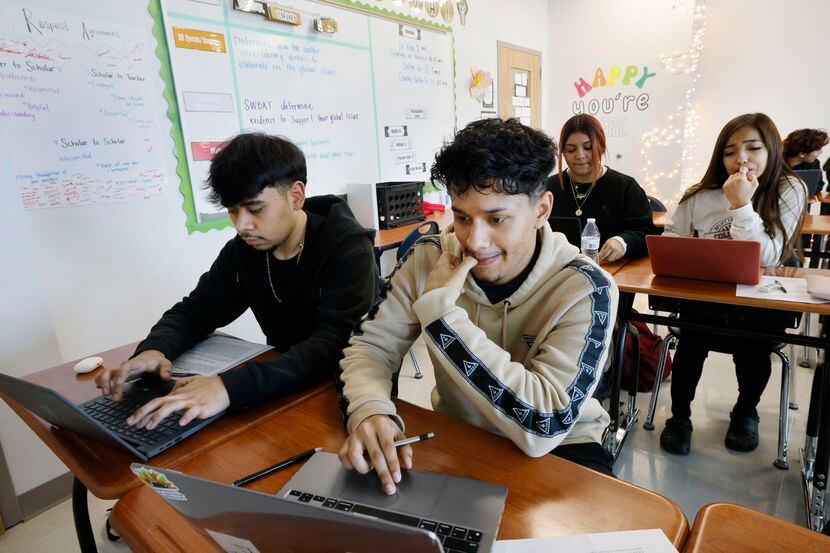 Ivan Rico, 17, left, and Alex Torres, 18, both 12th graders, work on laptops during a...