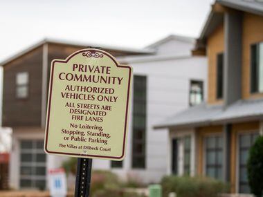 A sign designates The Villas at Dilbeck Court as a private community in the Garcia's West...
