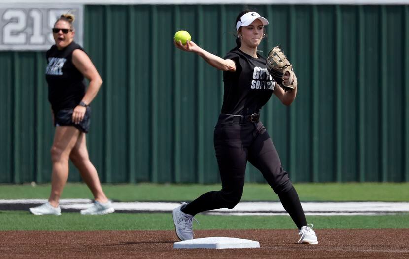 Denton Guyer softball player Kaylynn Jones turns a double play during practice at the...